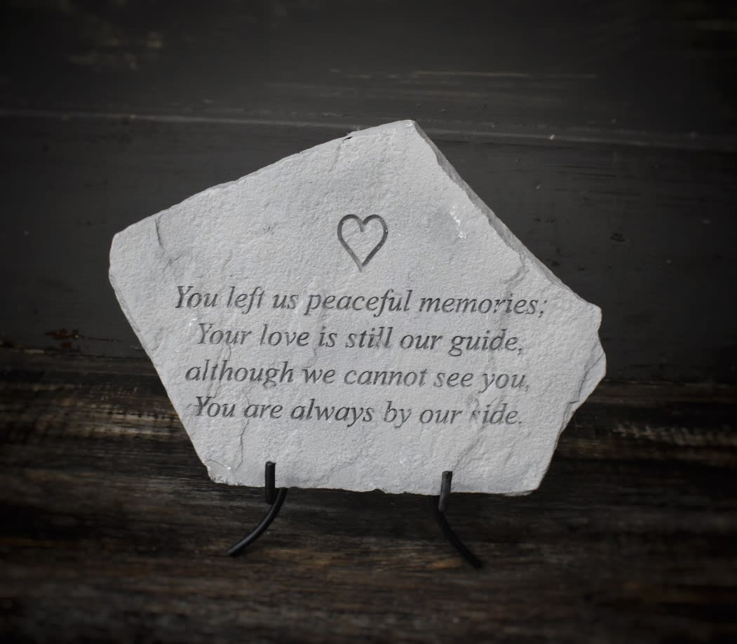 Memorial stone with an engraved sympathy verse and heart icon
