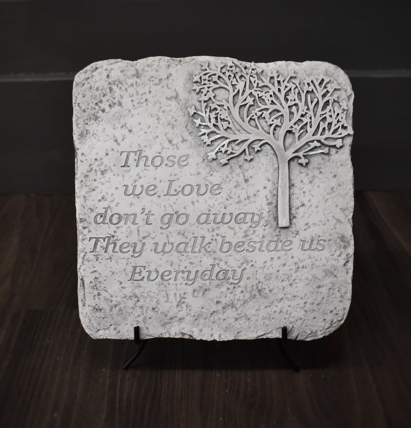 Decorative stone plaque with a tree and memorial quote
