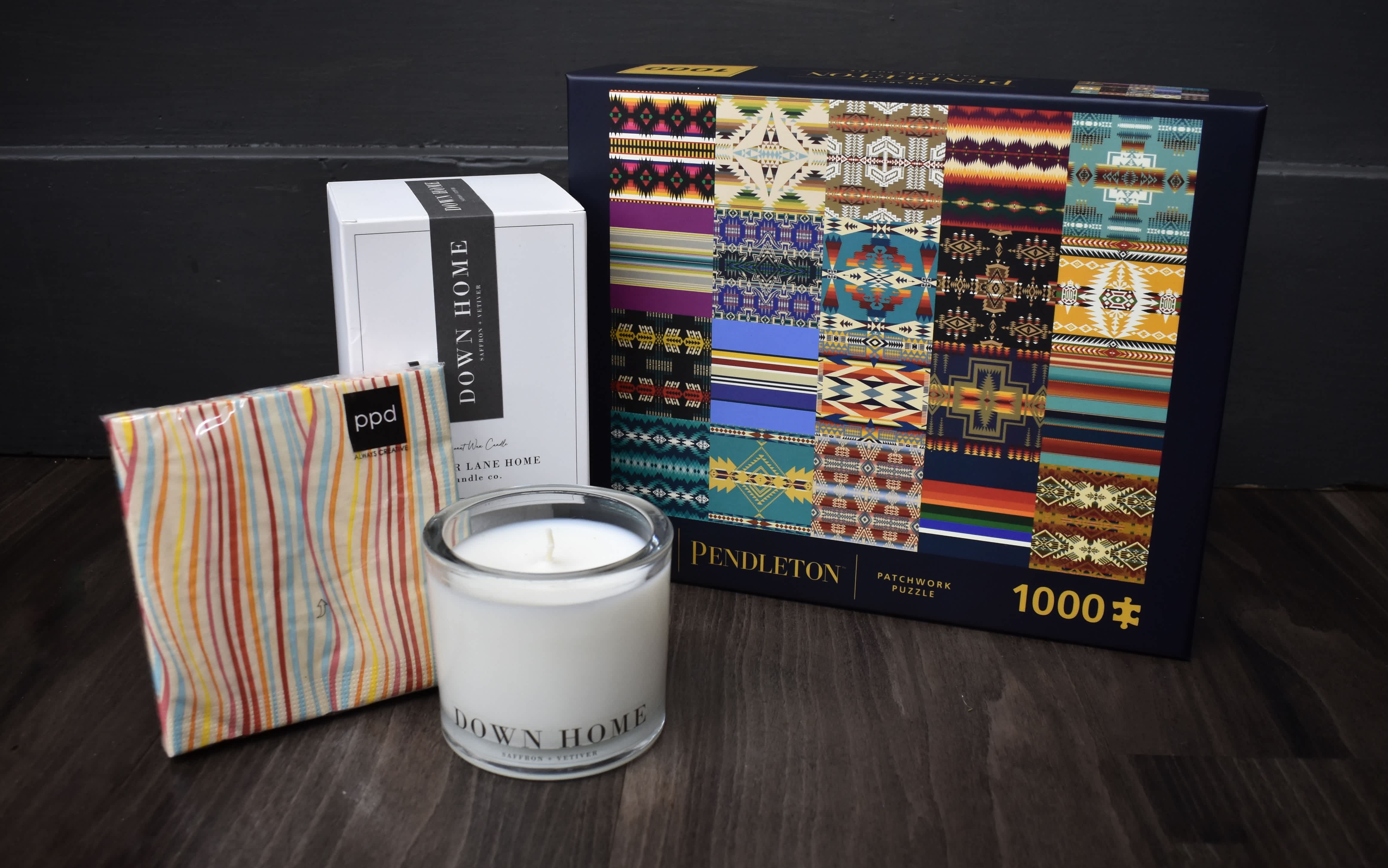 Candle, boxed candle, striped pouch, and a patterned puzzle box