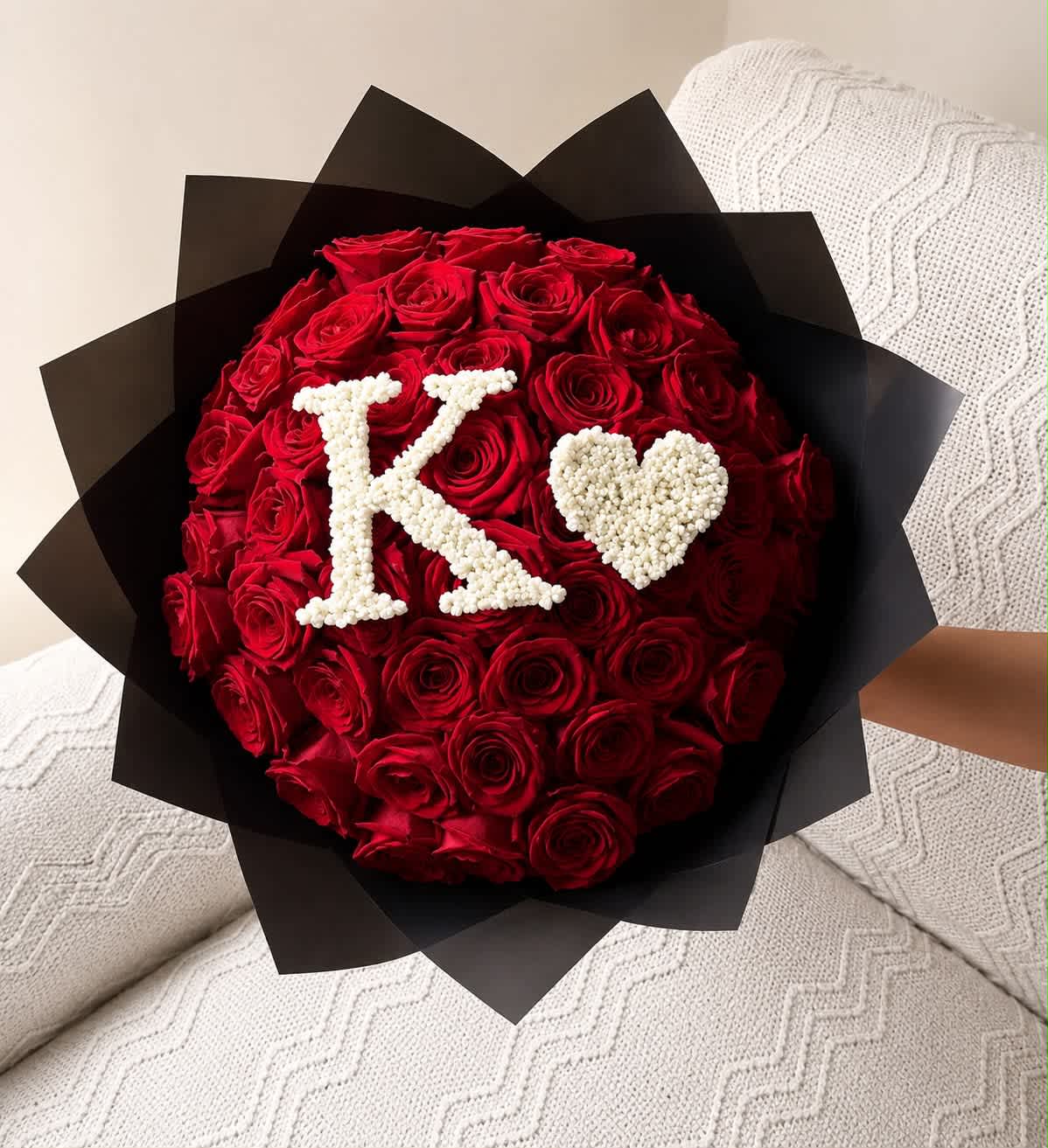 Red rose bouquet with a white K and heart on black wrap