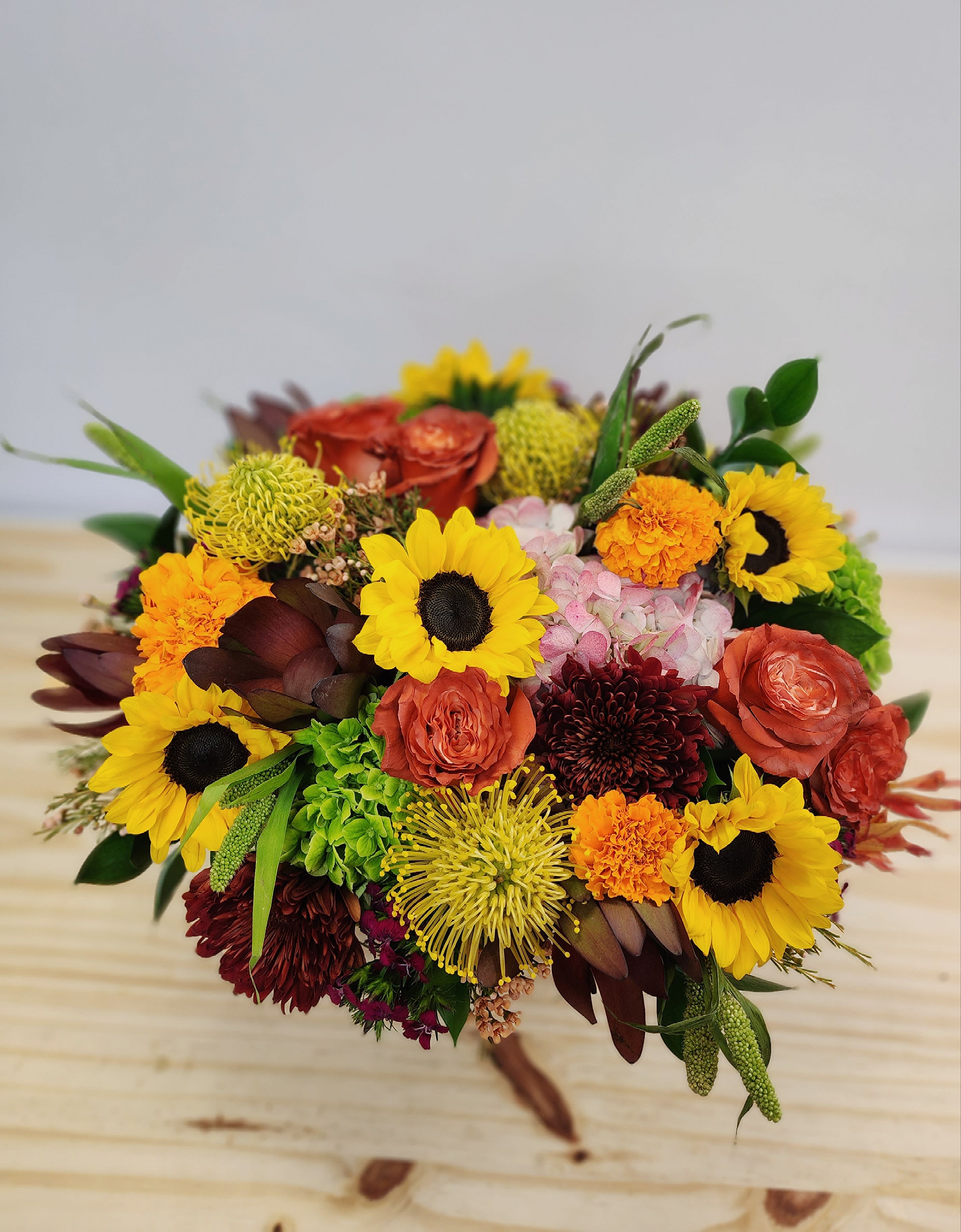 Harvest Blend Centerpiece  - Deluxe centerpiece of fresh assorted seasonal fall tones. Perfect for hosting gift or to complete the table. 