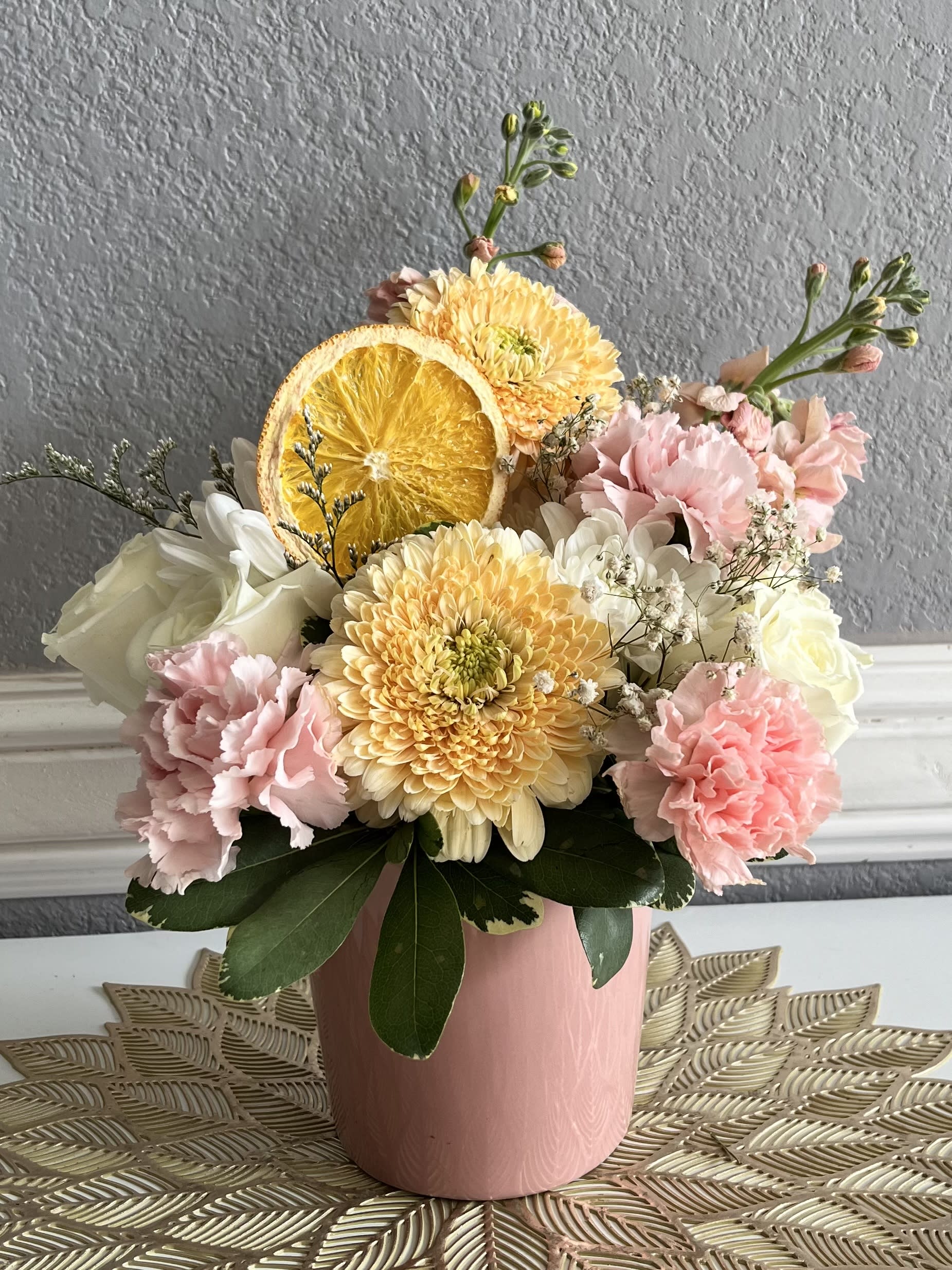 Pink and white bouquet with yellow chrysanthemums in a pink vase
