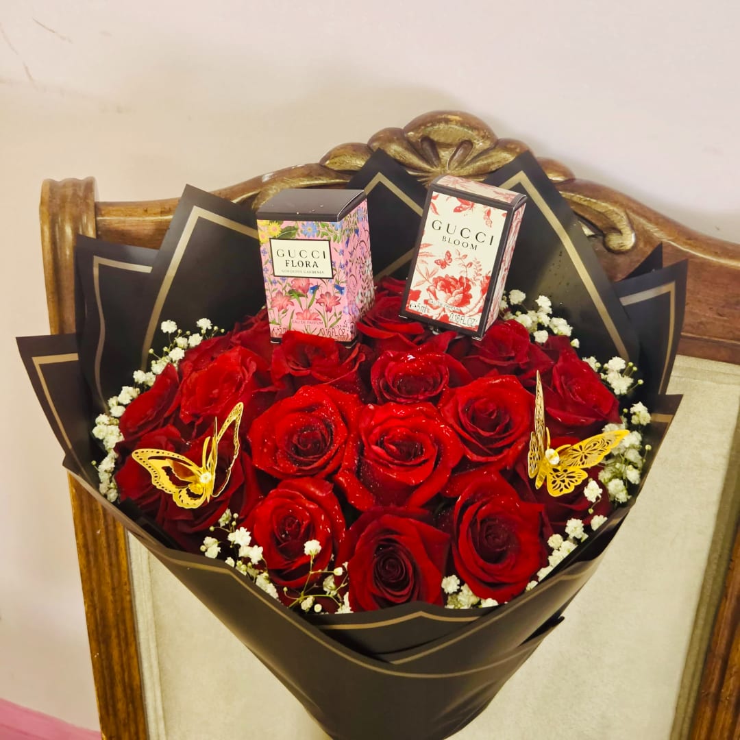 Bouquet of red roses with two perfume boxes and butterfly decorations