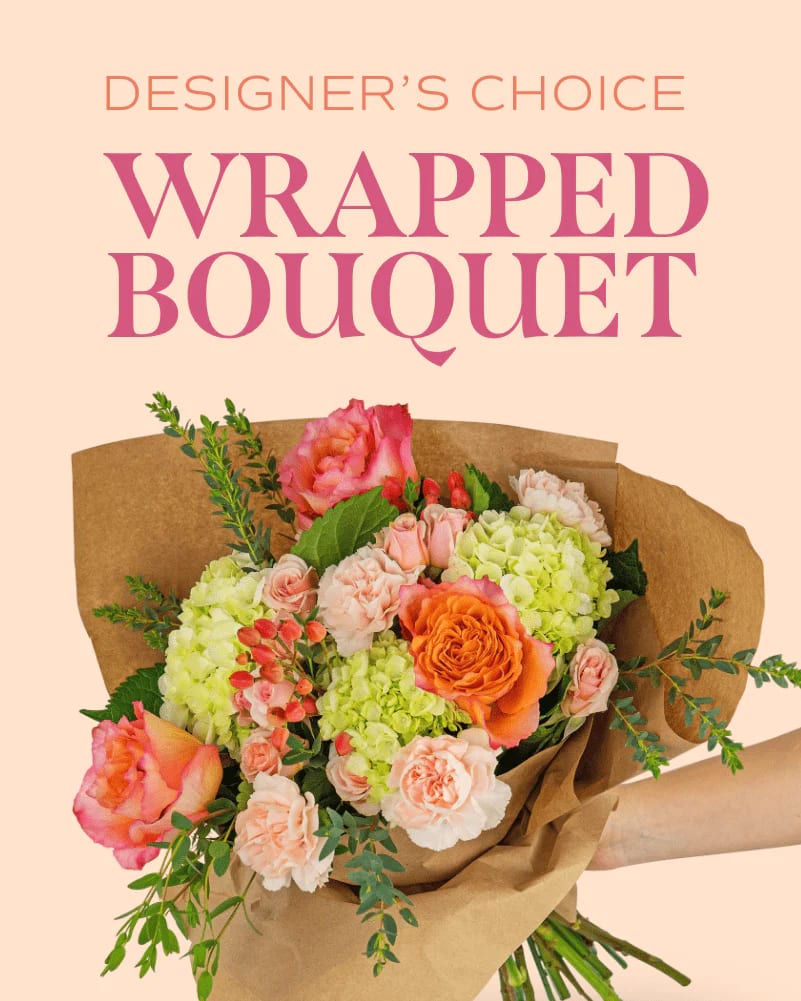 Wrapped bouquet of pink, peach, and green flowers in brown paper