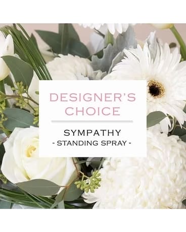 White sympathy standing spray with mixed blooms and greenery