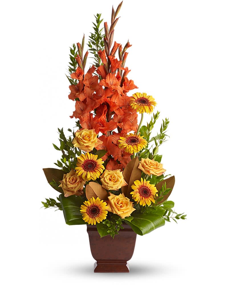 Tall orange and yellow floral arrangement in a brown vase