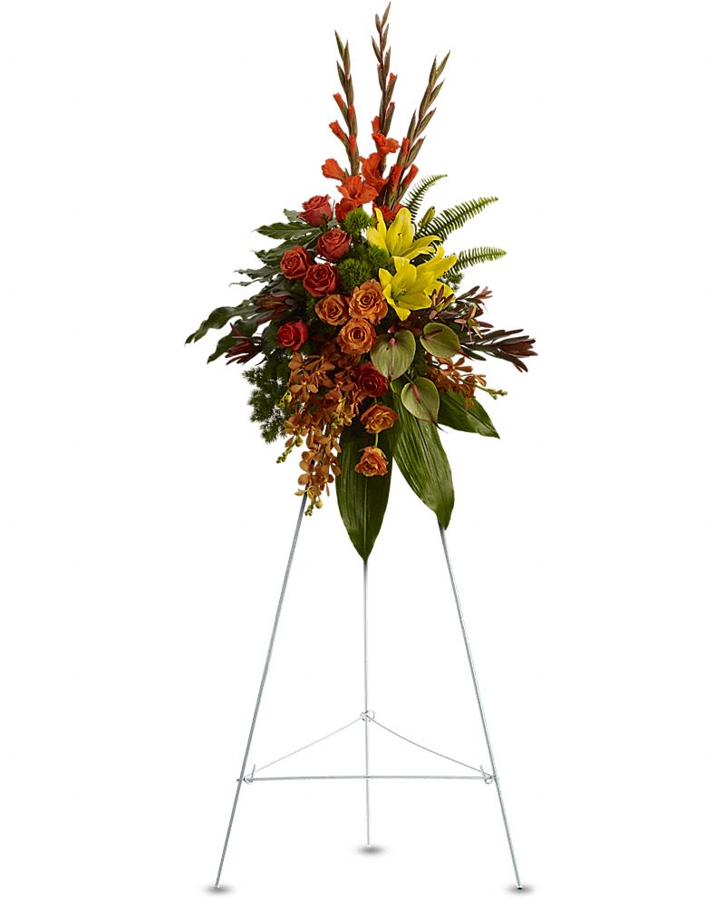 Tall floral standing spray with red, orange, and yellow blooms on a metal easel