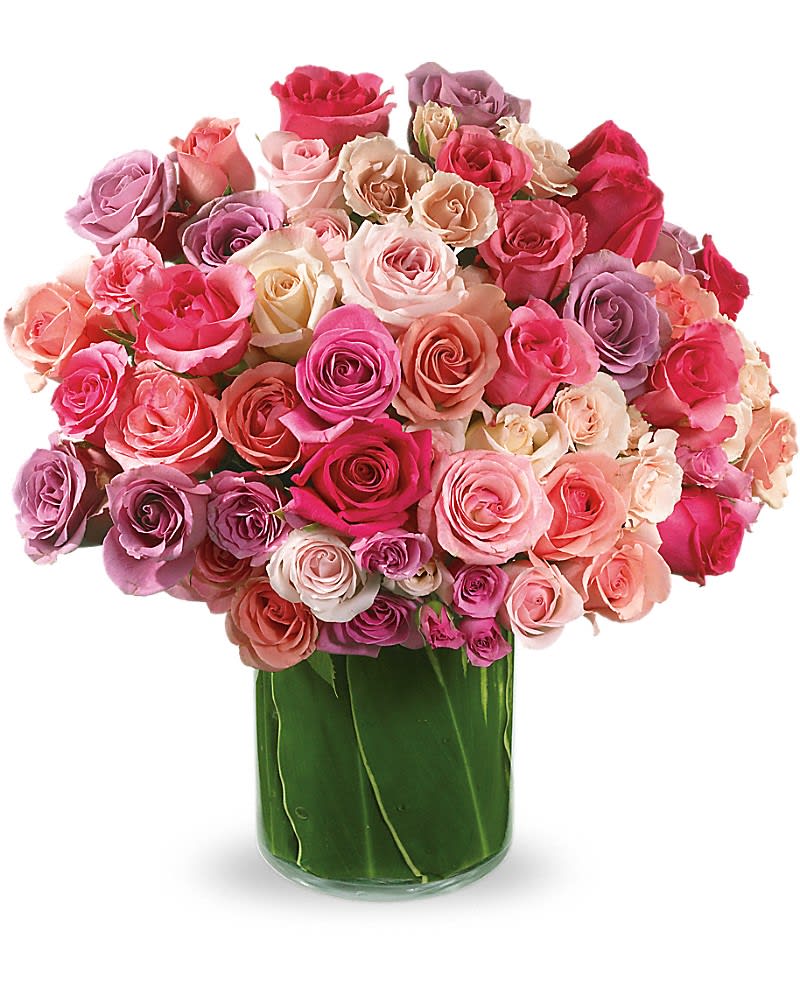 Large bouquet of pink and lavender roses in a glass vase