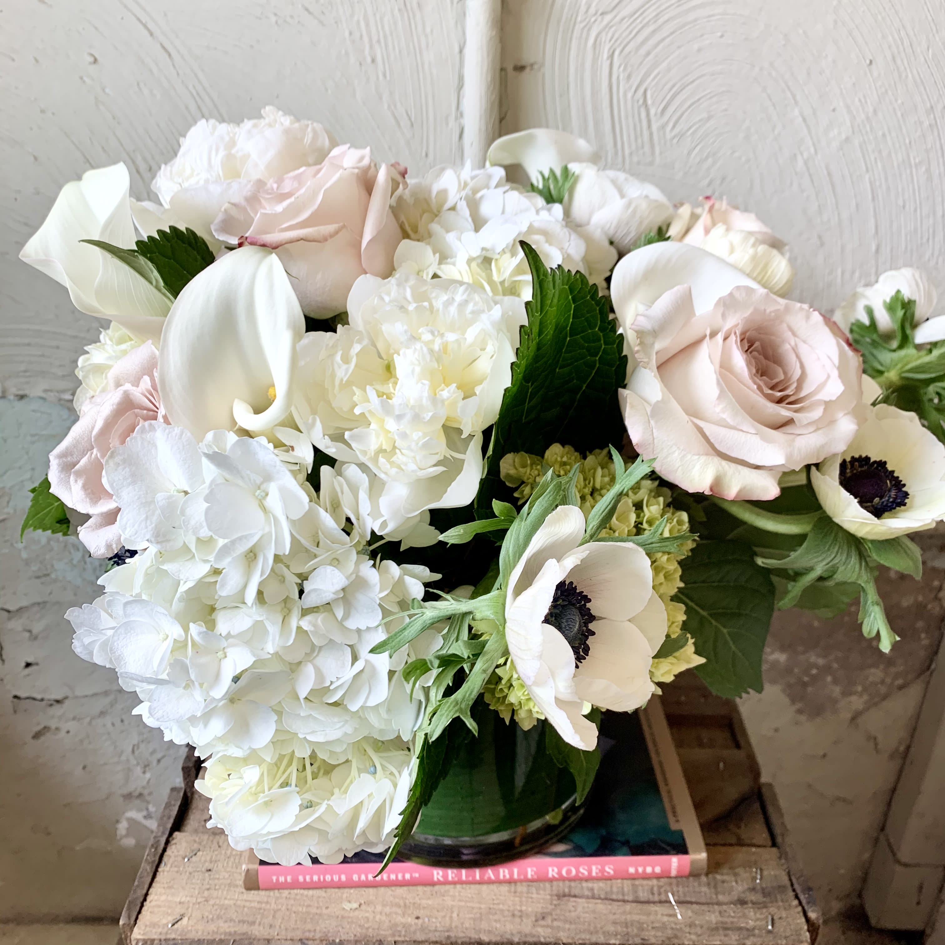 Bouquet of white and blush flowers in a glass vase