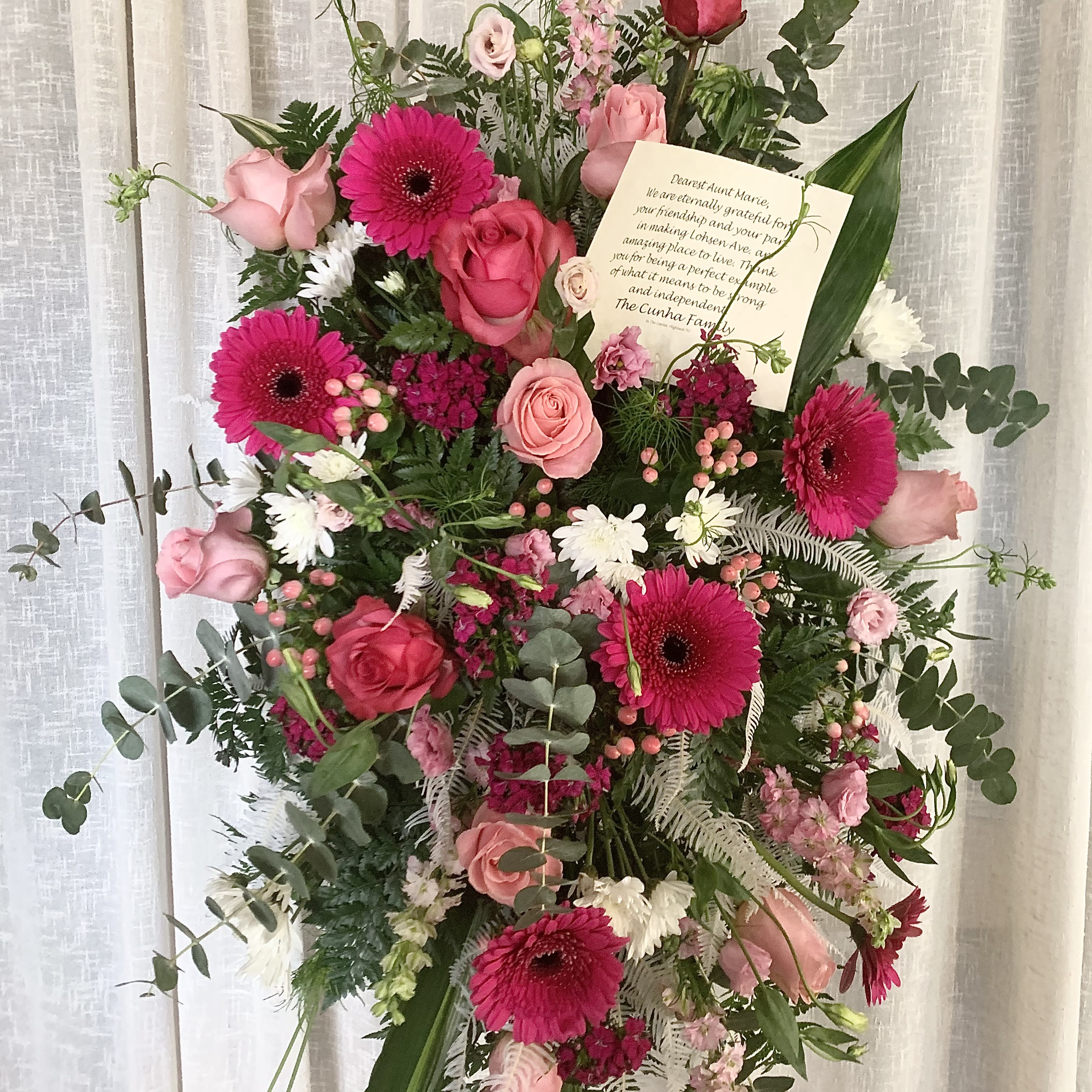 Memories in Pink Standing Spray - Celebrate the vibrant life of a lost loved one with a standing spray that truly encompasses their lively spirit. The Memories in Pink standing spray is a stunning addition to any funeral service, memorial service, or wake. This arrangement features radiant seasonal pink florals that brighten the sorrows of those who are grieving.