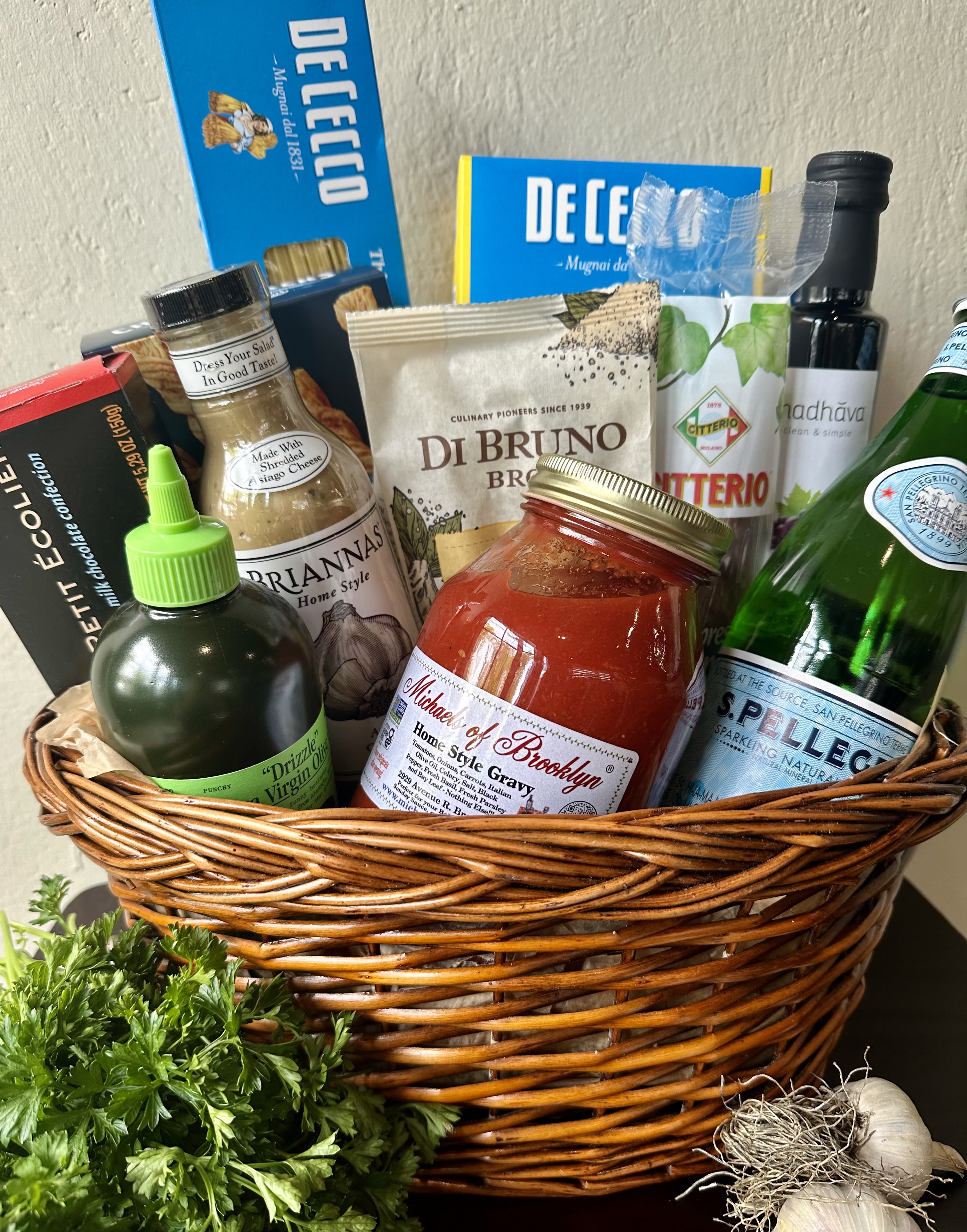 Gift basket with pasta, sauce, cheese, olive oil, and sparkling water