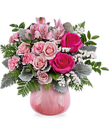 Pink roses and alstroemeria in a pink glass vase