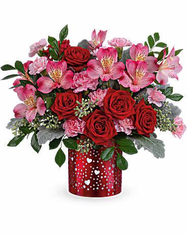 Red roses and pink alstroemeria in a red heart-patterned vase