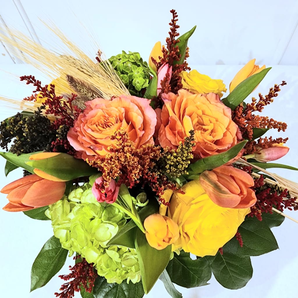 Bouquet of orange roses, yellow tulips, and green hydrangeas