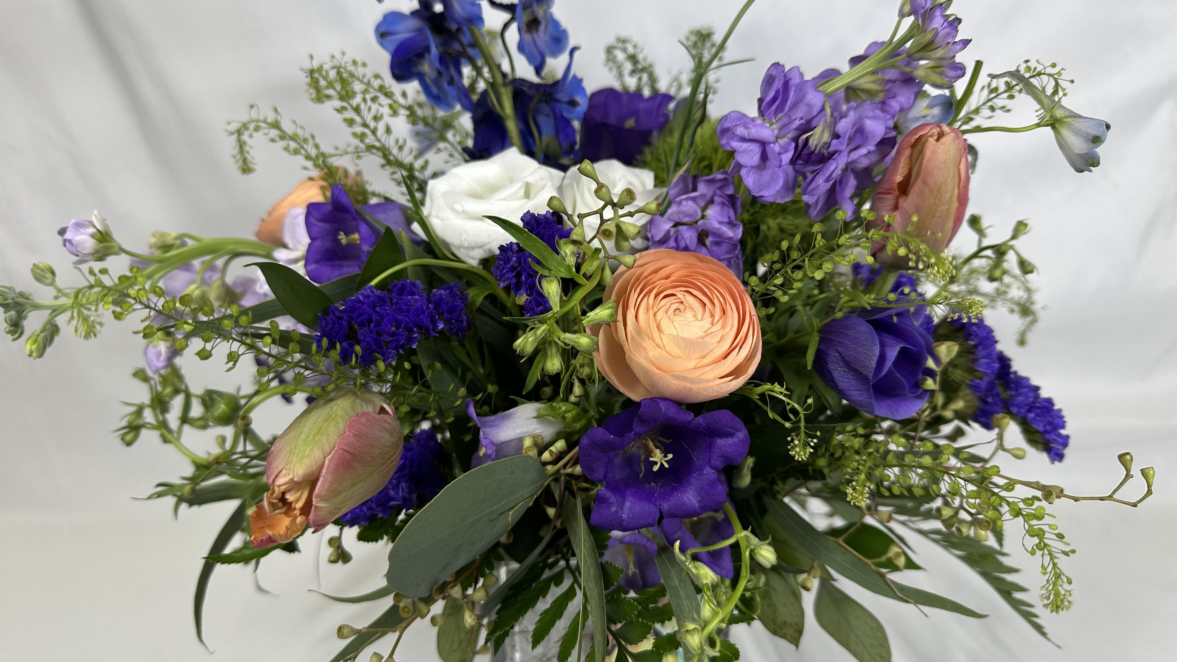 Butterfly Garden -  A charming bouquet in purple, white, and peach! This Leary's Flower's exclusive design looks delightful in a butterfly cube vase that will be a keepsake treasure after the flowers have bloomed. If the featured flowers are not available we will design your gift using the freshest available blooms of equal or greater value