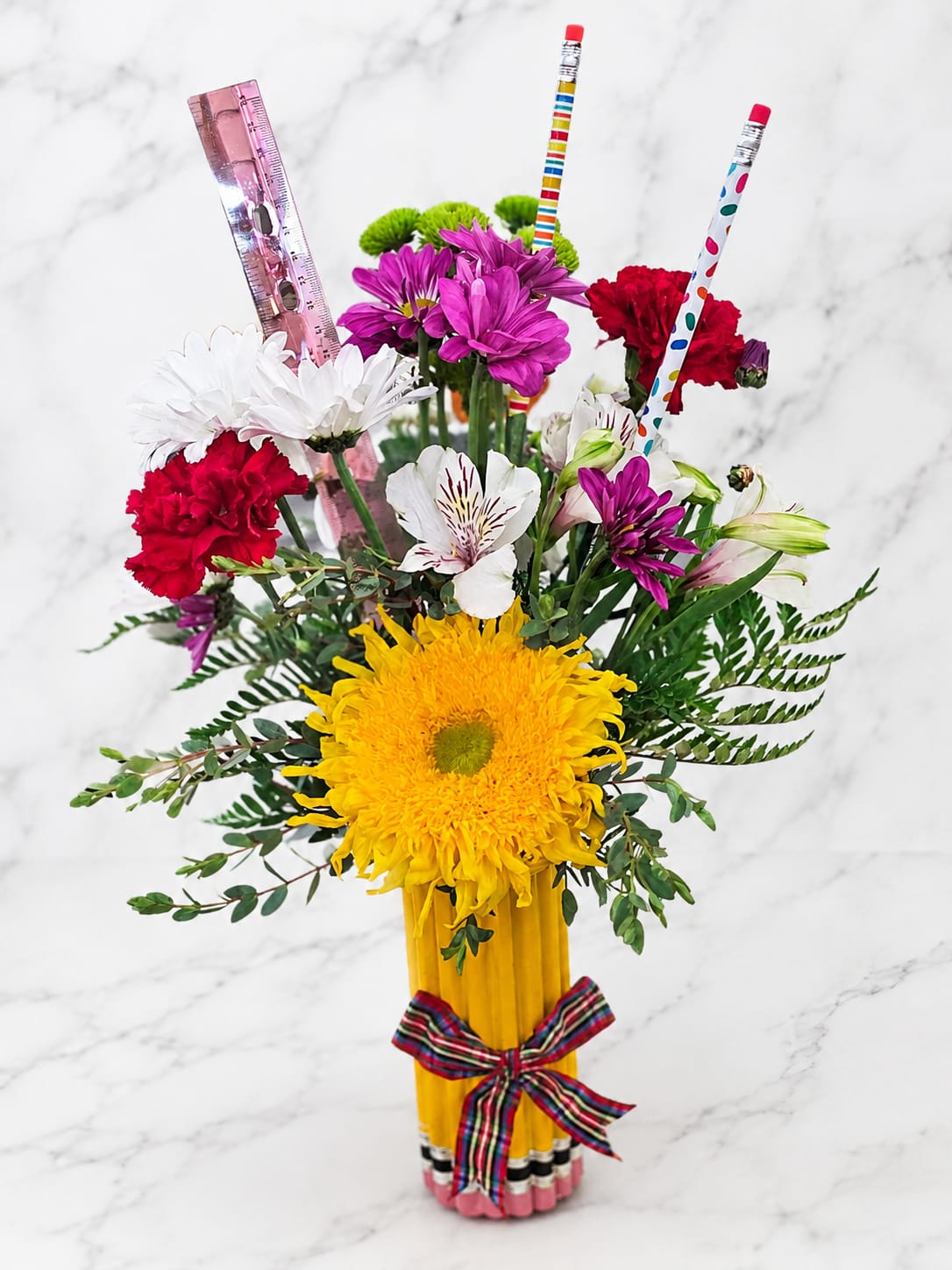 Colorful bouquet in a pencil vase with flowers and pencils