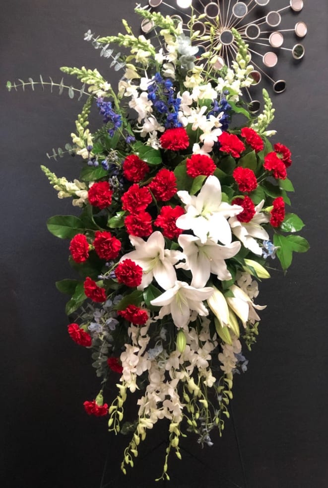 Standing floral spray with red carnations and white lilies