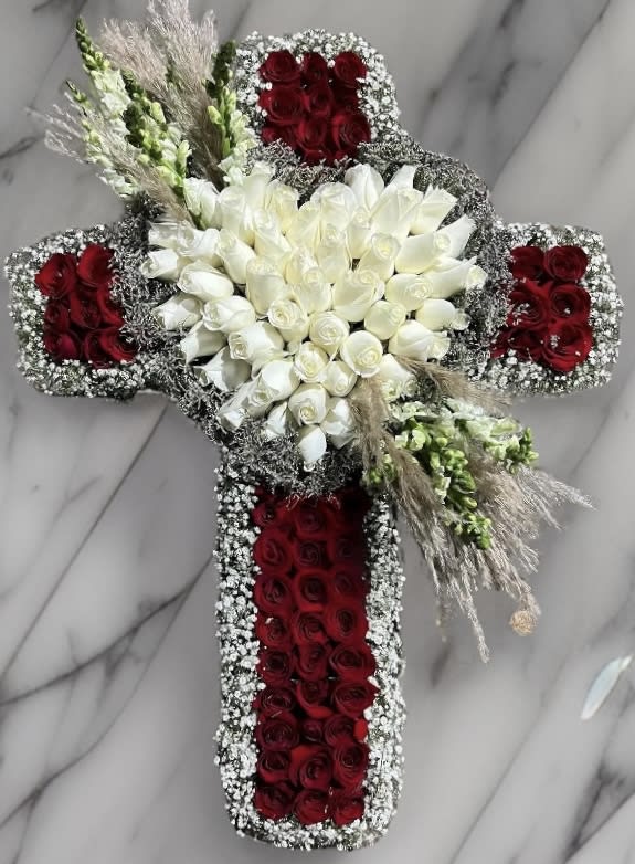 Cross-shaped floral arrangement with red and white roses