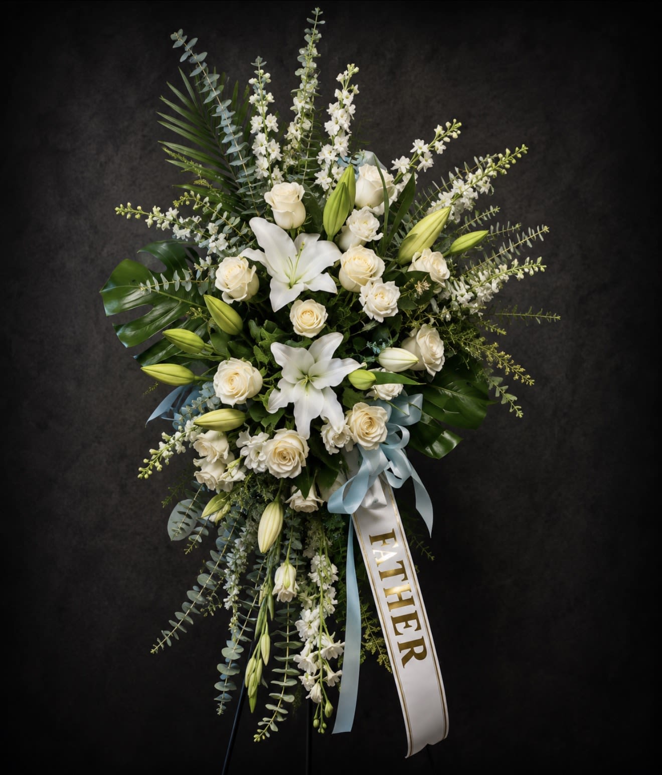 Serene Standing Spray Blue &amp; White - Helping someone find peace after the loss of a loved one can be difficult. If you want to offer your condolences through flowers, our timeless standing spray in blue and white is a beautiful choice. Shown in Premium Size