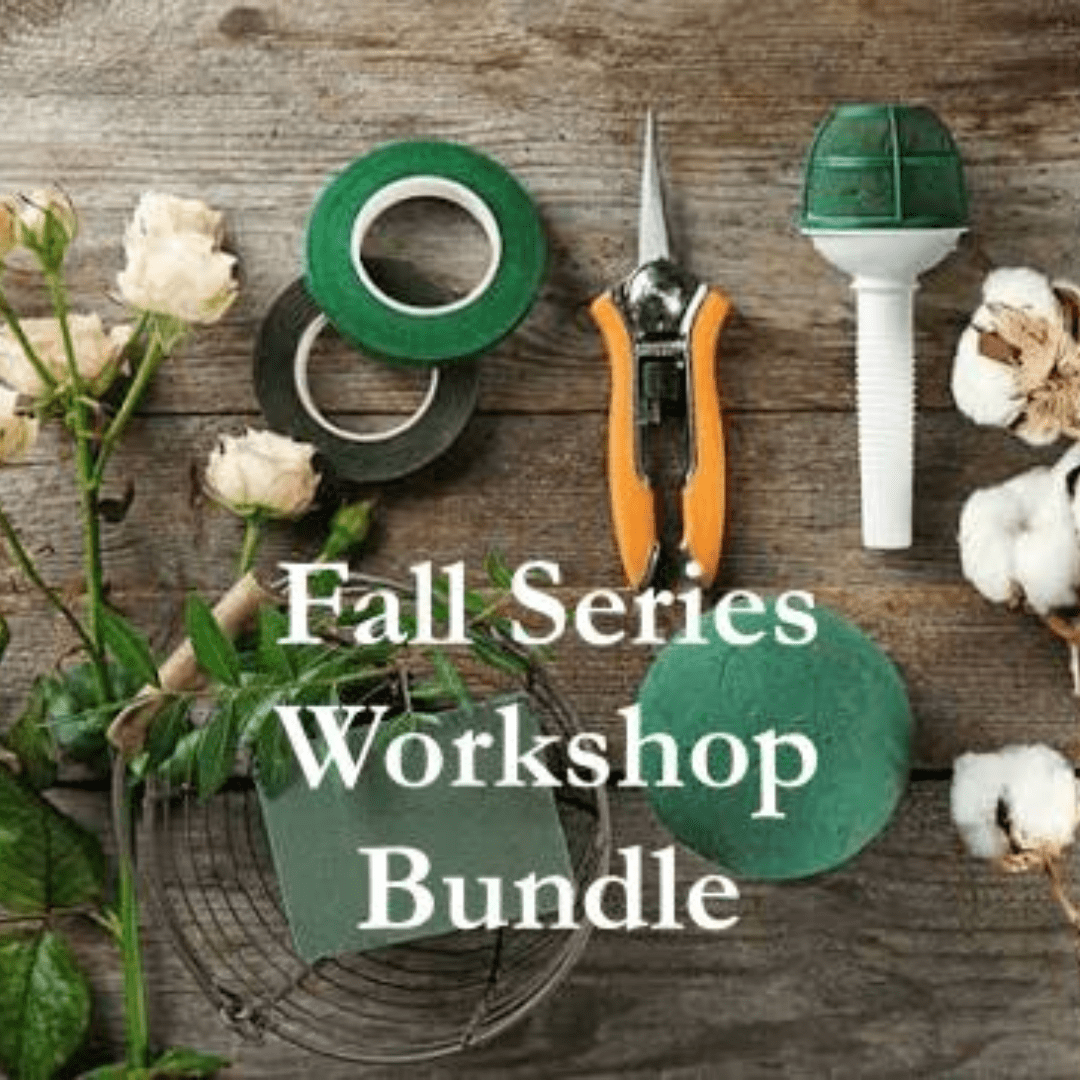 Floral workshop tools and cream roses arranged on a wooden surface