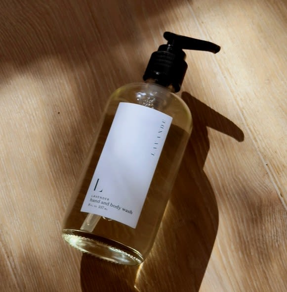 Bottle of hand and body wash on a wooden surface