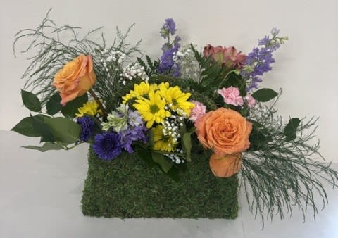 Fashionista in Bloom - Stylish, charming, and full of floral flair, Fashionista in Bloom is the perfect accessory for flower lovers. This delightful arrangement features a colorful mix of roses, stock, and daisies artfully designed in a decorative moss purse basket. Bursting with vibrant blooms and garden-fresh beauty, it combines fashion and flowers in one unforgettable gift. Perfect for birthdays, celebrations, thank-you gifts, or just because, Fashionista in Bloom is a fun and fashionable way to brighten someone's day.