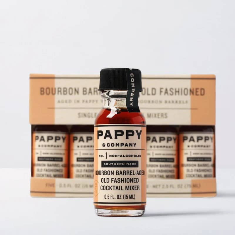 Bottle of non-alcoholic old fashioned cocktail mixer in front of a boxed set