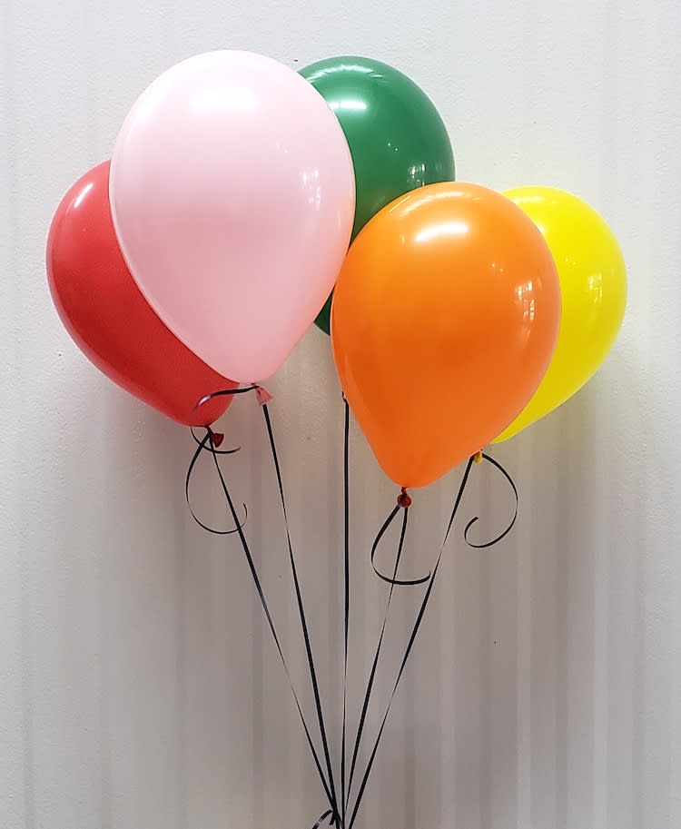 Cluster of colorful balloons against a plain wall