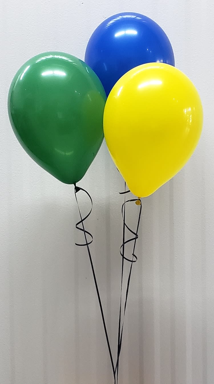 Three helium balloons in green, blue, and yellow with curling ribbons.