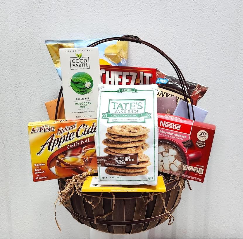 Gift basket filled with snack boxes and tea packets