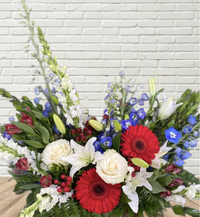 Mixed bouquet with red gerbera daisies, white roses, and lilies