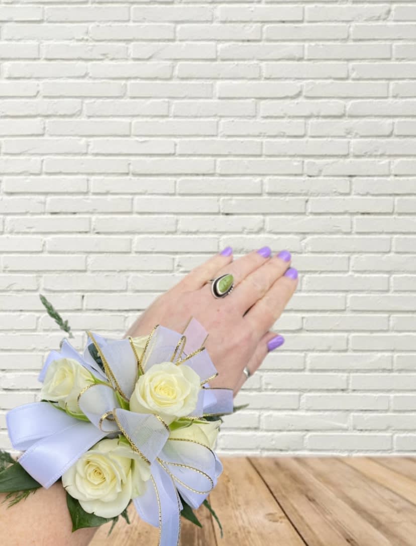 White rose wrist corsage with lavender ribbon and gold trim