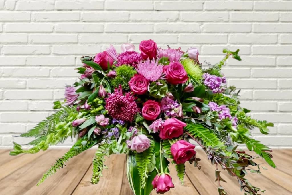Pink and purple floral arrangement in a glass vase