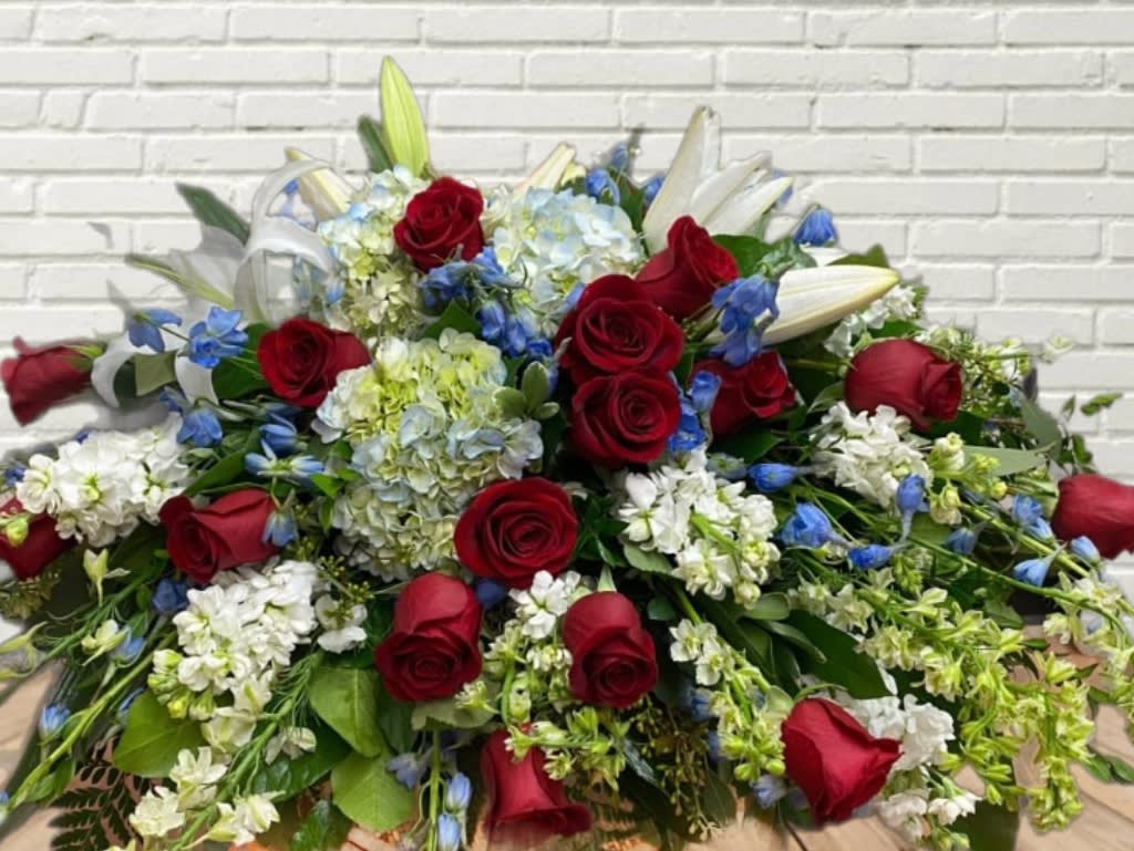 Large bouquet of red roses, white lilies, and blue flowers