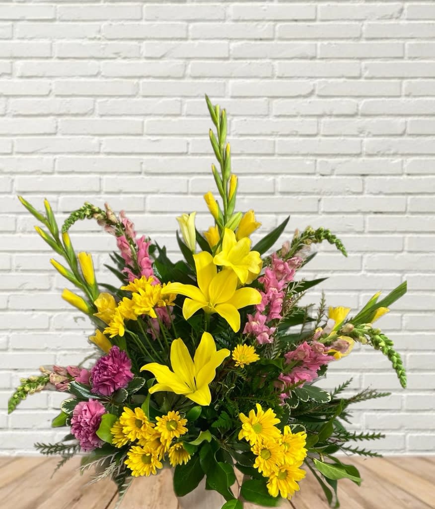 Yellow lilies and pink flowers in a mixed bouquet