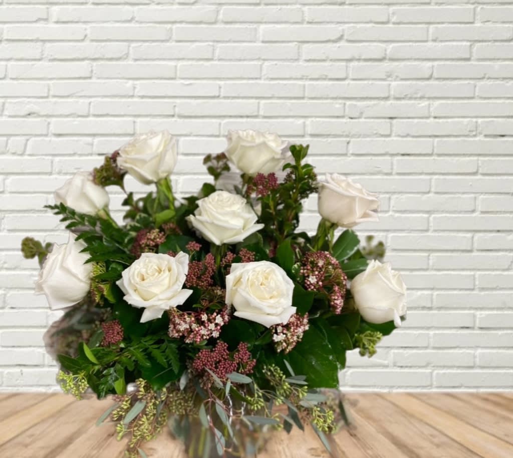 White rose bouquet with pink filler flowers and greenery