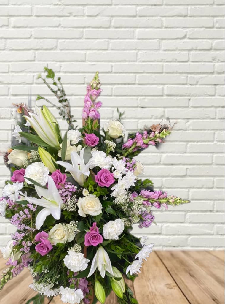 Large bouquet of white lilies, pink roses, and purple flowers