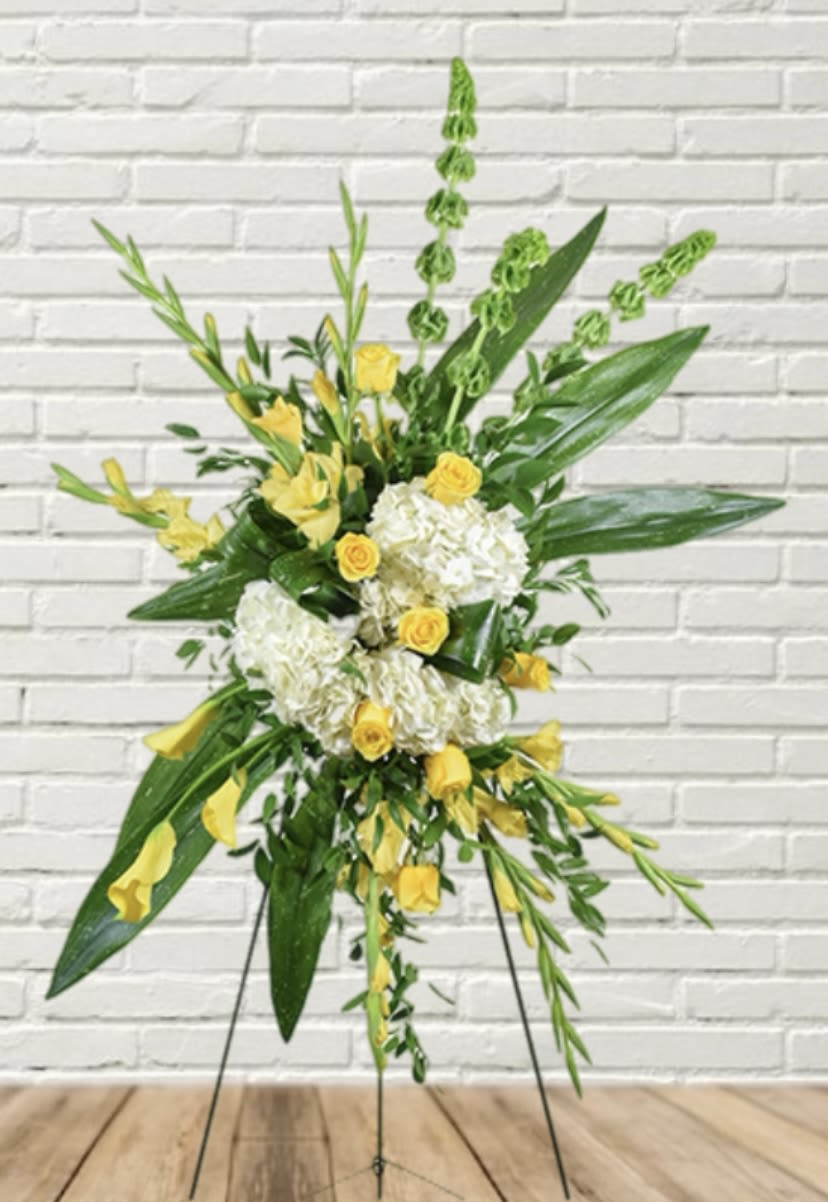 Tall floral standing spray with yellow roses and white hydrangeas