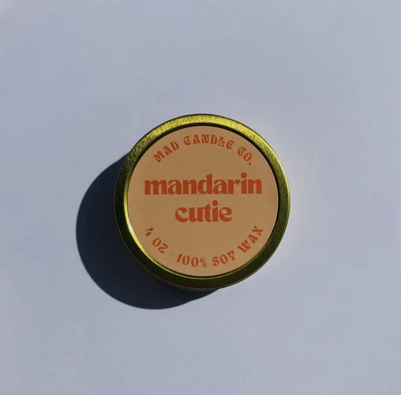 Mandarin Cutie Soy Candle - 4 oz Gold Tin &amp; Wood Wick - Enhance any room with the summery vibe of Mandarin Cutie's lively and refreshing scent. Combining the invigorating and rejuvenating aroma of orange, grapefruit, and lemon, it'll set the perfect mood and elevate your senses.  Notes: Orange, mandarin, grapefruit, lemon, and peach.  PRODUCT DETAILS -4 oz / Burn time: 15 hours / Dimensions: 3.25" L x 3.25" W x 1.25" H -Sustainable crackling wood wick that sounds like a cozy fireplace -Vegan, Cruelty-free, Non-toxic, Paraben-free &amp; Phthalate-free -Hand-poured in Eugene, Oregon