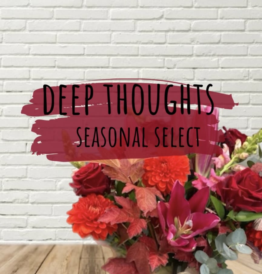 Bouquet of red and pink flowers with a seasonal select sign