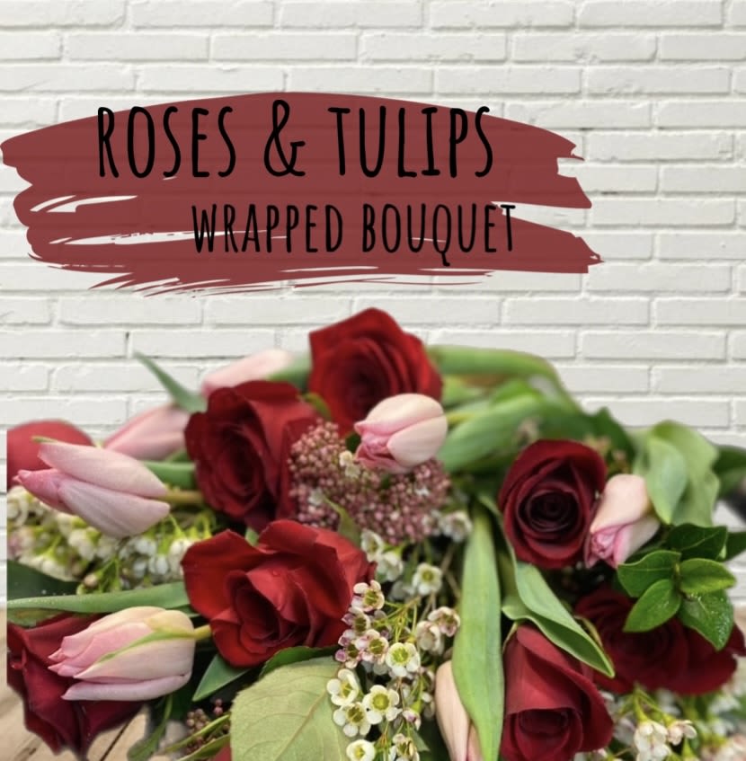 Wrapped bouquet of red roses and pink tulips
