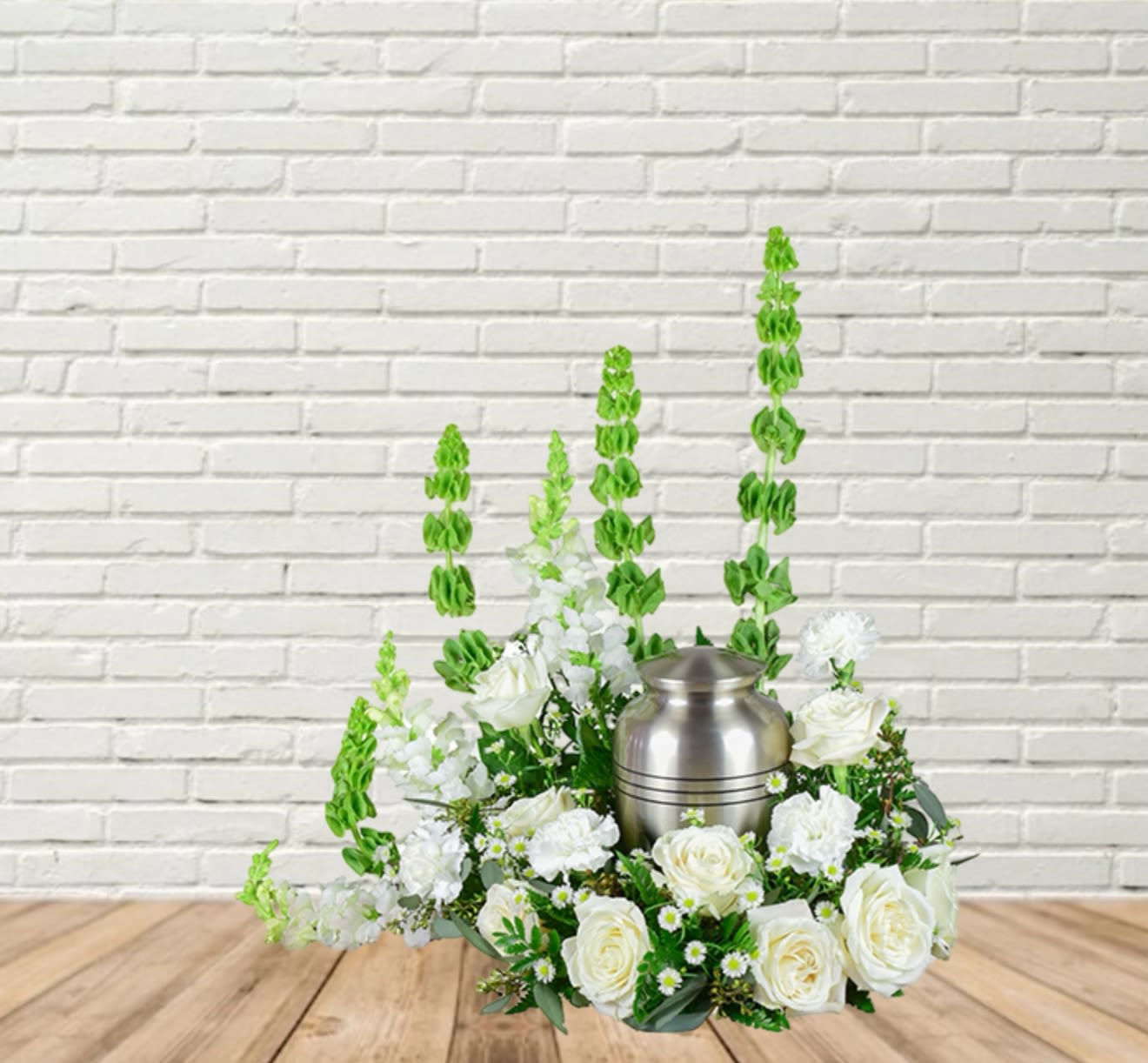 White floral arrangement with a silver urn centerpiece