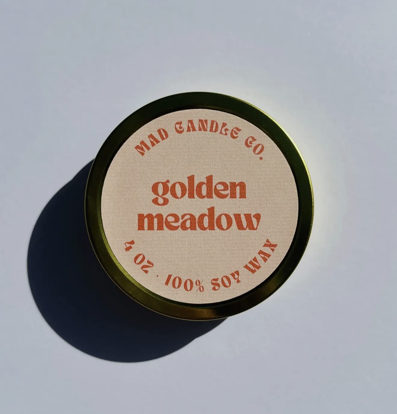 Golden Meadow Soy Candle - 4 oz Gold Tin &amp; Wood Wick - Orange Blossom • Lemon Verbena • Wildflowers • Fresh Grass  A sunlit stroll through wildflower fields. The bright, citrusy zing of lemon verbena and orange blossom dances with the fresh dewy aroma of wildflowers and freshly cut grass. A perfect harmony of brightness and nature's bounty, like the warmth of the sun on a summer day.