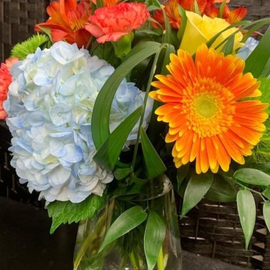 Bouquet with blue hydrangea, orange gerbera daisies, and yellow roses