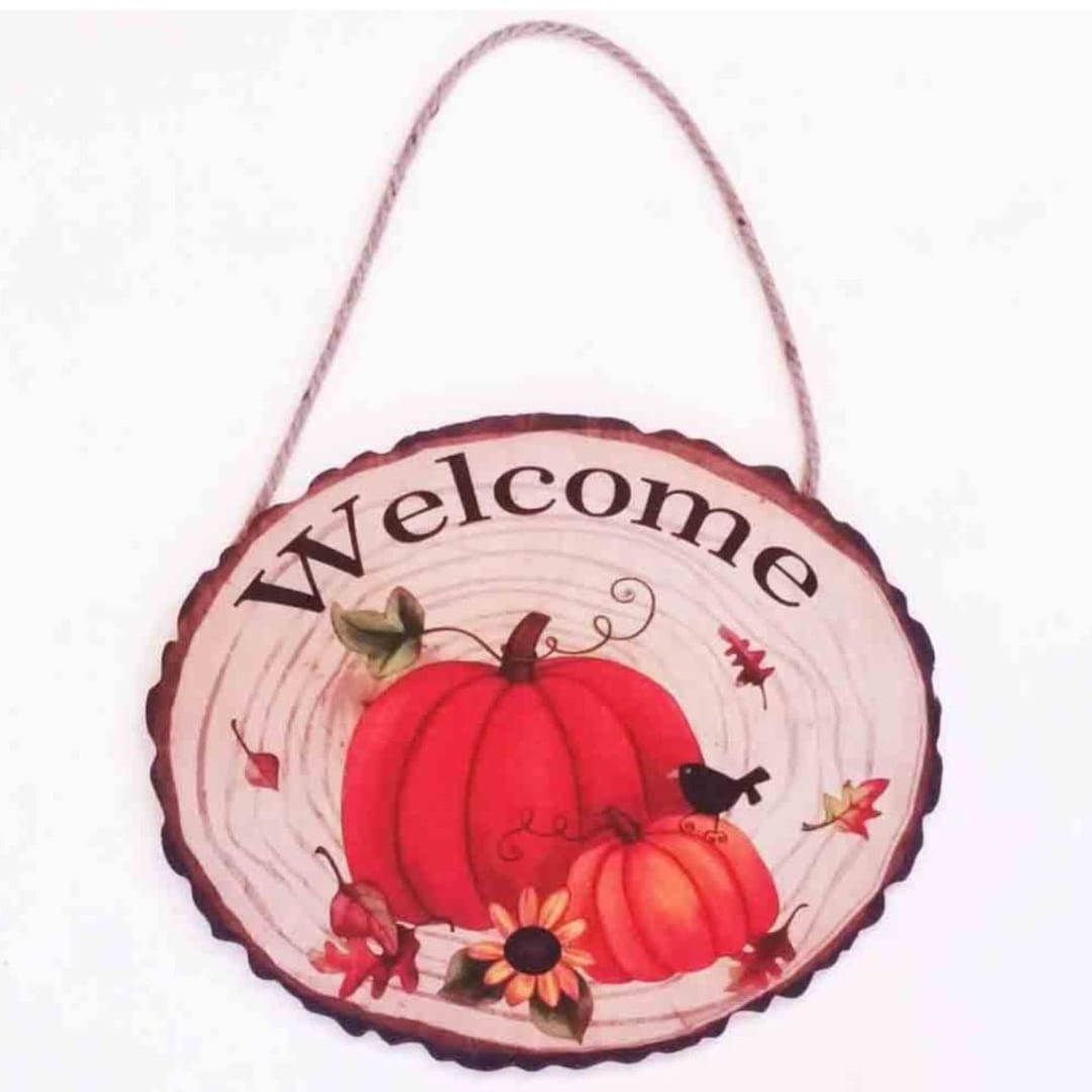 Round hanging sign with pumpkins and the word Welcome