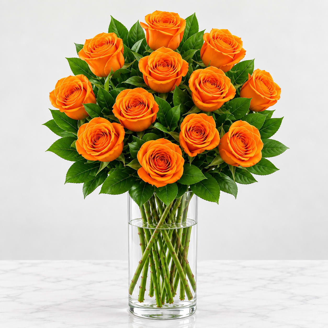 Orange roses arranged in a clear glass vase