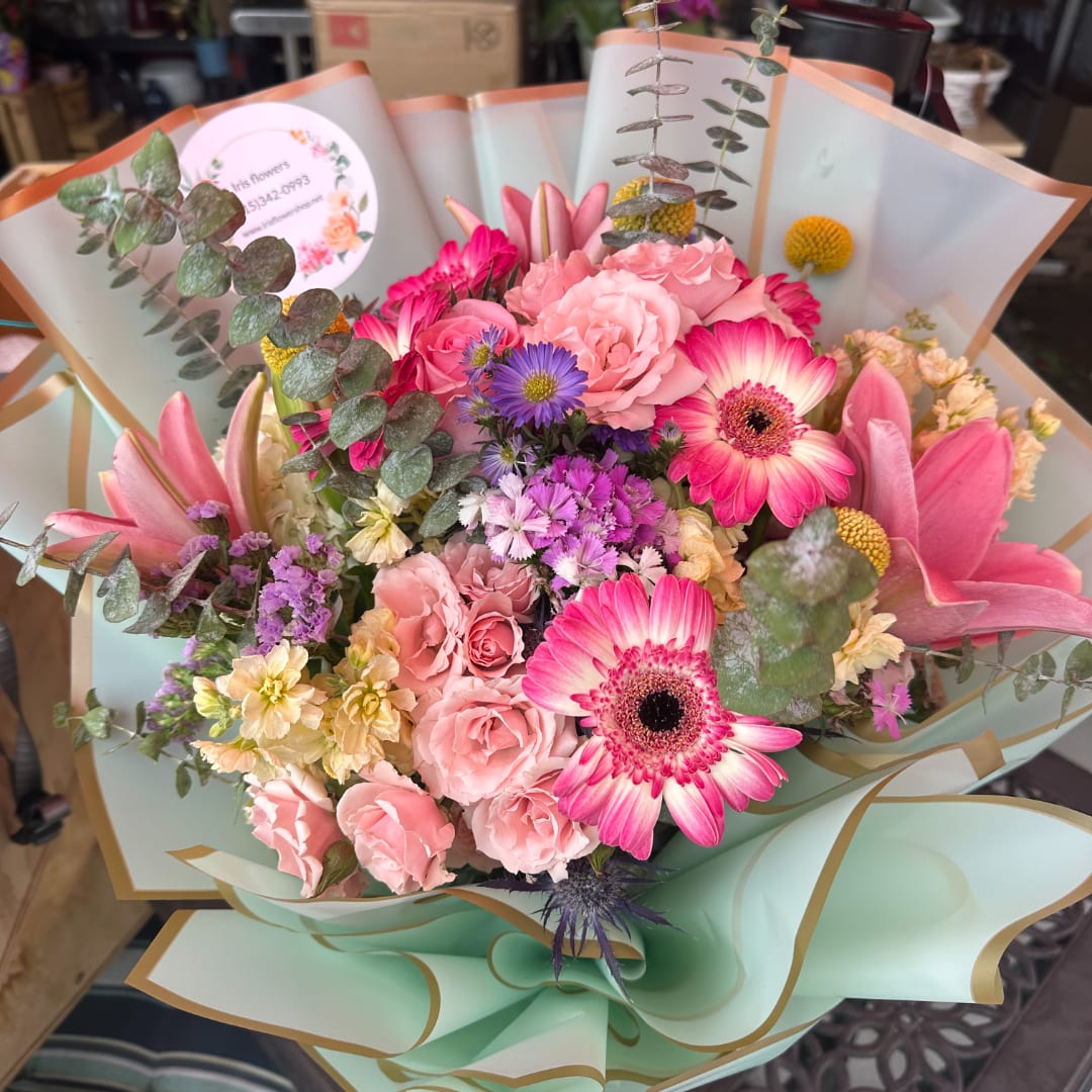 Pink mixed bouquet with gerbera daisies and roses wrapped in pastel paper