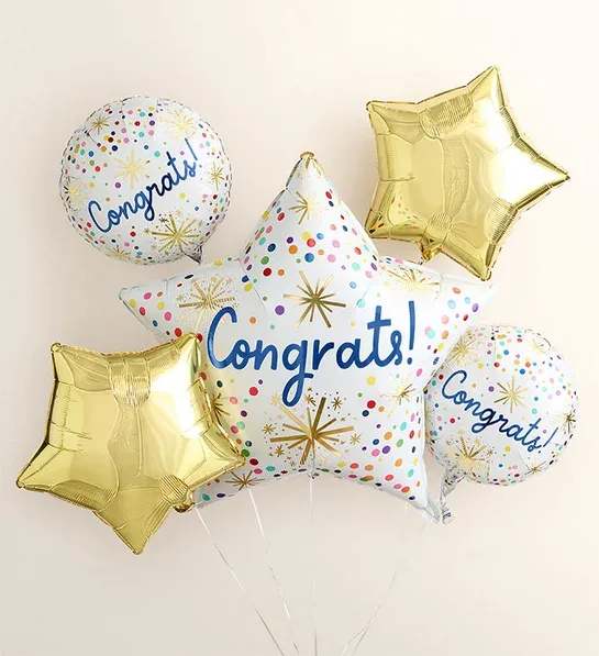 Cluster of congratulatory star-shaped and round balloons
