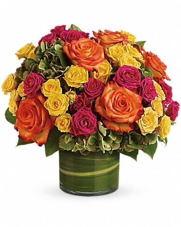 Bouquet of orange, yellow, and pink roses in a green vase