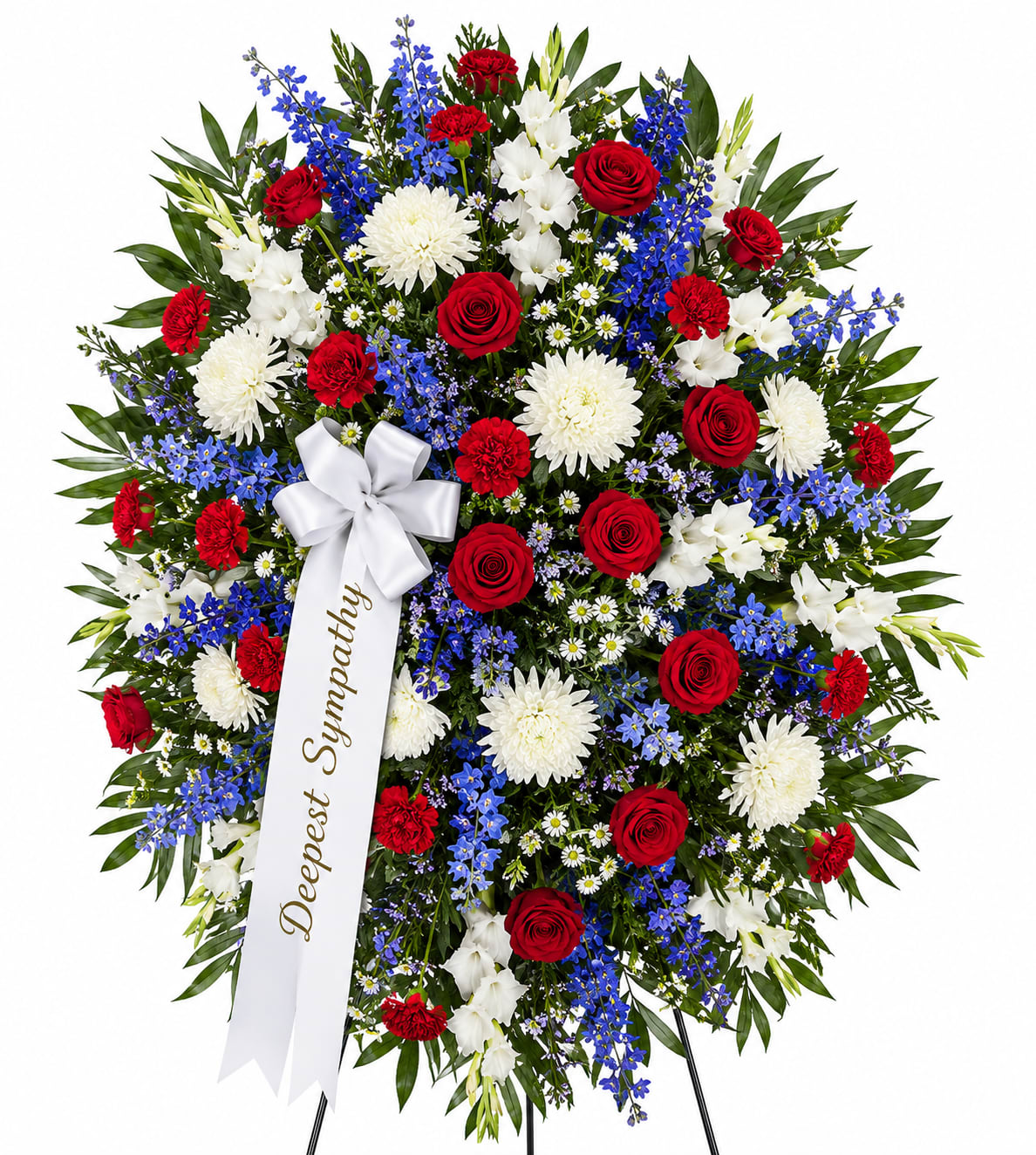 Patriotic Tribute Standing Spray - A timeless expression of love, honor, and remembrance, this elegant standing spray is thoughtfully designed to convey your deepest condolences. Featuring a harmonious blend of radiant red roses, pure white chrysanthemums, delicate white blooms, and vibrant blue accents, this arrangement creates a beautiful and respectful tribute.  Accented with lush greenery and finished with a satin ribbon bearing a heartfelt message, this standing spray is a meaningful way to celebrate a life well lived and offer comfort during difficult times.  Perfect for funeral services, memorials, or graveside ceremonies, this arrangement stands as a symbol of dignity, respect, and everlasting love.